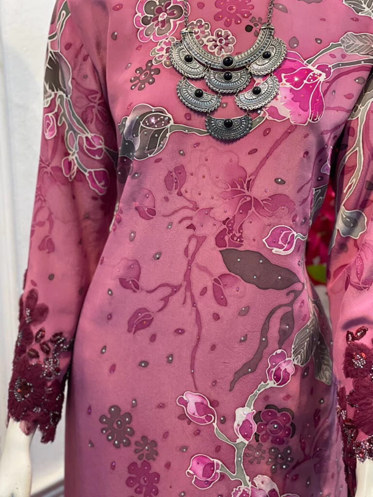 Close-up of the hand-drawn floral batik, diamonds and maroon lace cuffs of baju kurung RSQ D 7